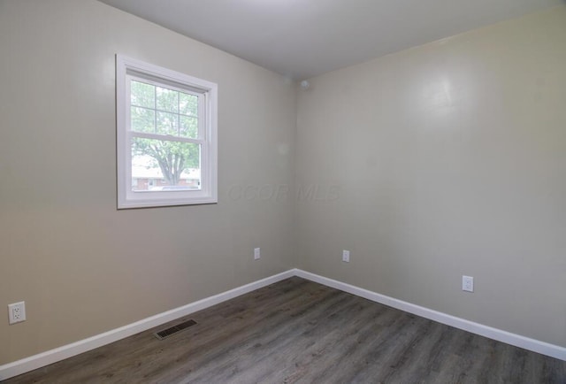 1541 Taft St, Marion, OH 43302 - spare room with baseboards and dark wood-style floors