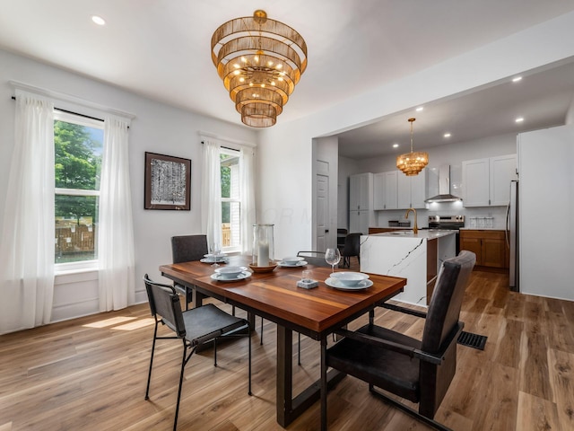 883 Wilson Ave, Columbus, OH 43206 - dining room featuring a chandelier, wood finished floors, and recessed lighting