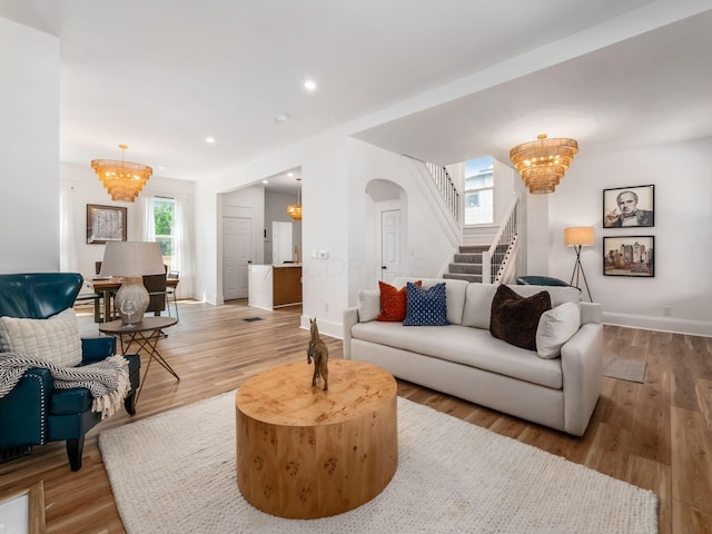 883 Wilson Ave, Columbus, OH 43206 - living room featuring a chandelier, stairway, wood finished floors, baseboards, and recessed lighting