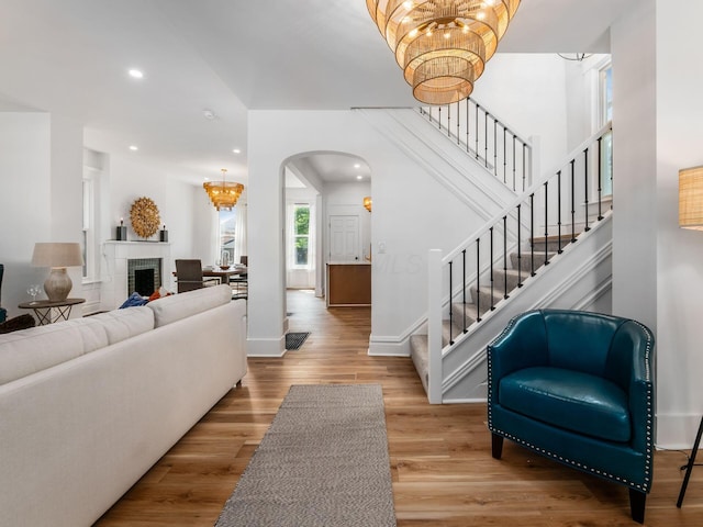 883 Wilson Ave, Columbus, OH 43206 - living room with a chandelier, arched walkways, stairway, recessed lighting, and wood finished floors