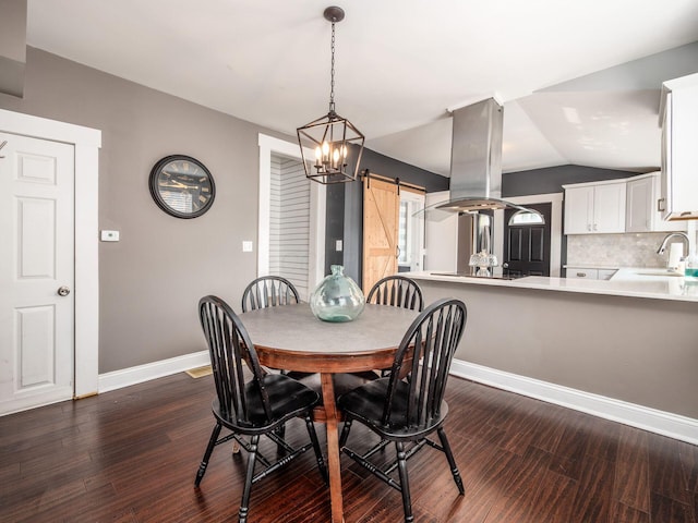 533 Stewart Ave, Columbus, OH 43206 - dining room featuring a barn door, dark wood-type flooring, vaulted ceiling, baseboards, and a chandelier
