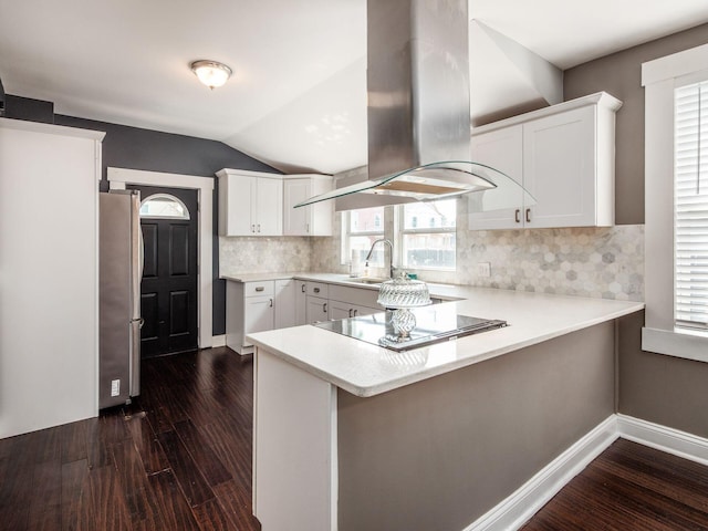 533 Stewart Ave, Columbus, OH 43206 - kitchen with island exhaust hood, freestanding refrigerator, a peninsula, dark wood-type flooring, and black electric cooktop