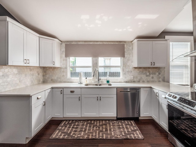 533 Stewart Ave, Columbus, OH 43206 - kitchen featuring appliances with stainless steel finishes, a sink, dark wood-type flooring, decorative backsplash, and light countertops