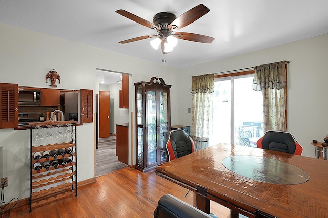 1067 Bronwyn Ave, Columbus, OH 43204 - dining area with a ceiling fan, light wood-style flooring, and baseboards