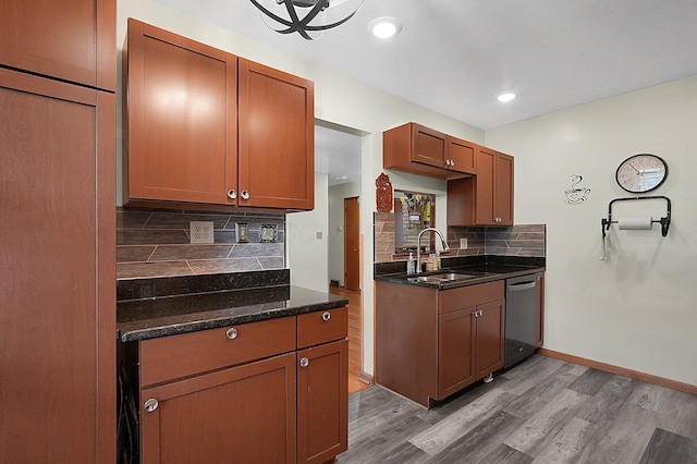 1067 Bronwyn Ave, Columbus, OH 43204 - kitchen featuring a sink, stainless steel dishwasher, dark wood-type flooring, tasteful backsplash, and baseboards