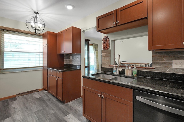 1067 Bronwyn Ave, Columbus, OH 43204 - kitchen with stainless steel dishwasher, a sink, plenty of natural light, and tasteful backsplash