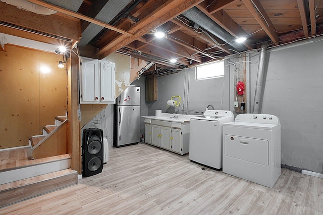 1067 Bronwyn Ave, Columbus, OH 43204 - laundry room featuring washer and dryer, cabinet space, and light wood finished floors