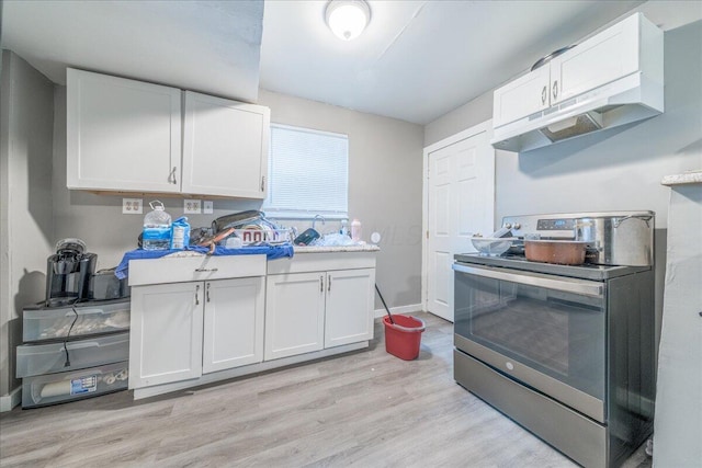 476 Graham St, Columbus, OH 43203 - kitchen featuring stainless steel electric range, light wood-type flooring, white cabinetry, baseboards, and light countertops