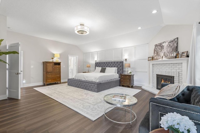 7276 Lee Rd, Westerville, OH 43081 - bedroom with lofted ceiling, dark wood finished floors, a fireplace, baseboards, and recessed lighting