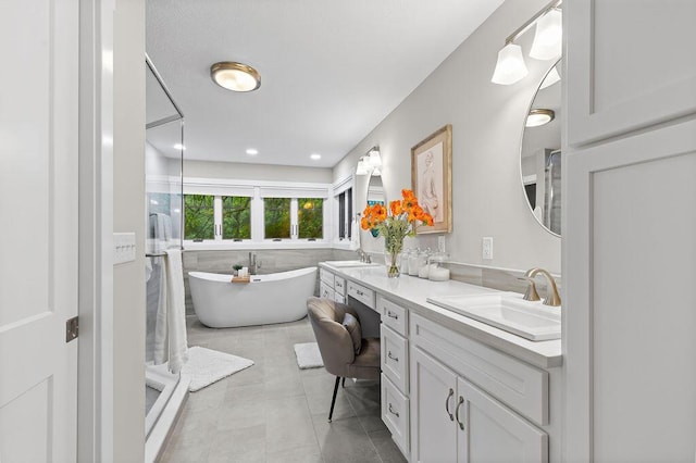 7276 Lee Rd, Westerville, OH 43081 - full bathroom with double vanity, a freestanding tub, tile patterned flooring, and a shower