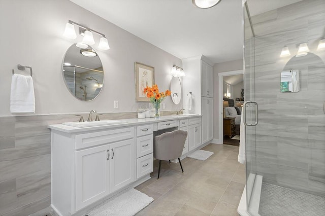 7276 Lee Rd, Westerville, OH 43081 - full bathroom with double vanity, a stall shower, tile patterned flooring, and tile walls