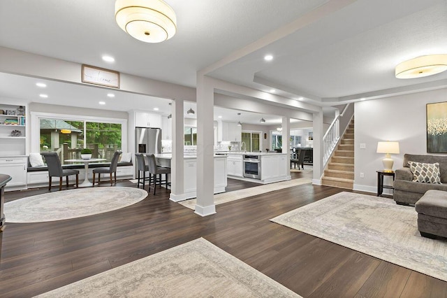 7276 Lee Rd, Westerville, OH 43081 - living room with stairs, dark wood finished floors, baseboards, and recessed lighting