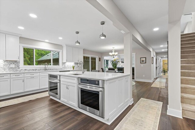 7276 Lee Rd, Westerville, OH 43081 - kitchen featuring stainless steel oven, a sink, light countertops, a chandelier, and recessed lighting