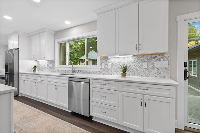 7276 Lee Rd, Westerville, OH 43081 - kitchen featuring appliances with stainless steel finishes, a sink, light countertops, white cabinetry, and dark wood finished floors