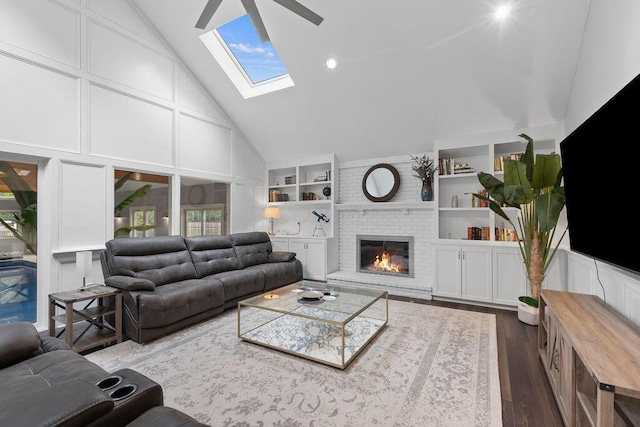 7276 Lee Rd, Westerville, OH 43081 - living room featuring high vaulted ceiling, dark wood-style flooring, a brick fireplace, a skylight, and built in features