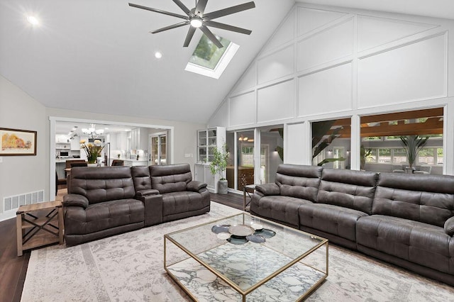 7276 Lee Rd, Westerville, OH 43081 - living area featuring high vaulted ceiling, ceiling fan, a chandelier, wood finished floors, and a skylight