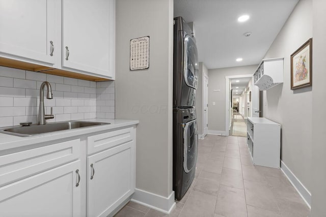 7276 Lee Rd, Westerville, OH 43081 - washroom with stacked washer / drying machine, cabinet space, baseboards, recessed lighting, and light tile patterned floors