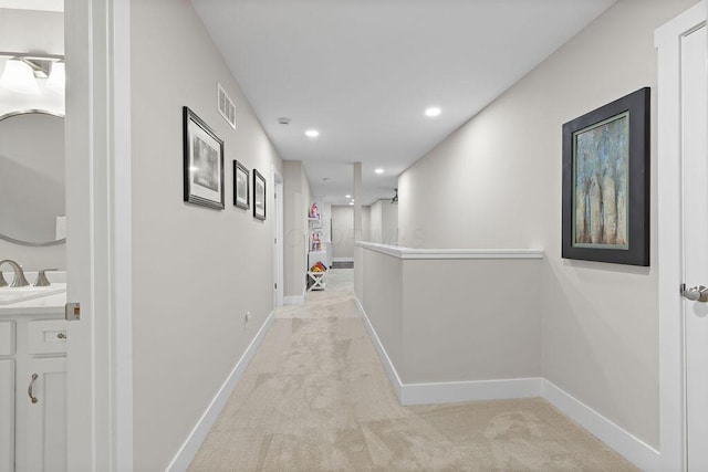 7276 Lee Rd, Westerville, OH 43081 - hall with light carpet, baseboards, recessed lighting, and a sink