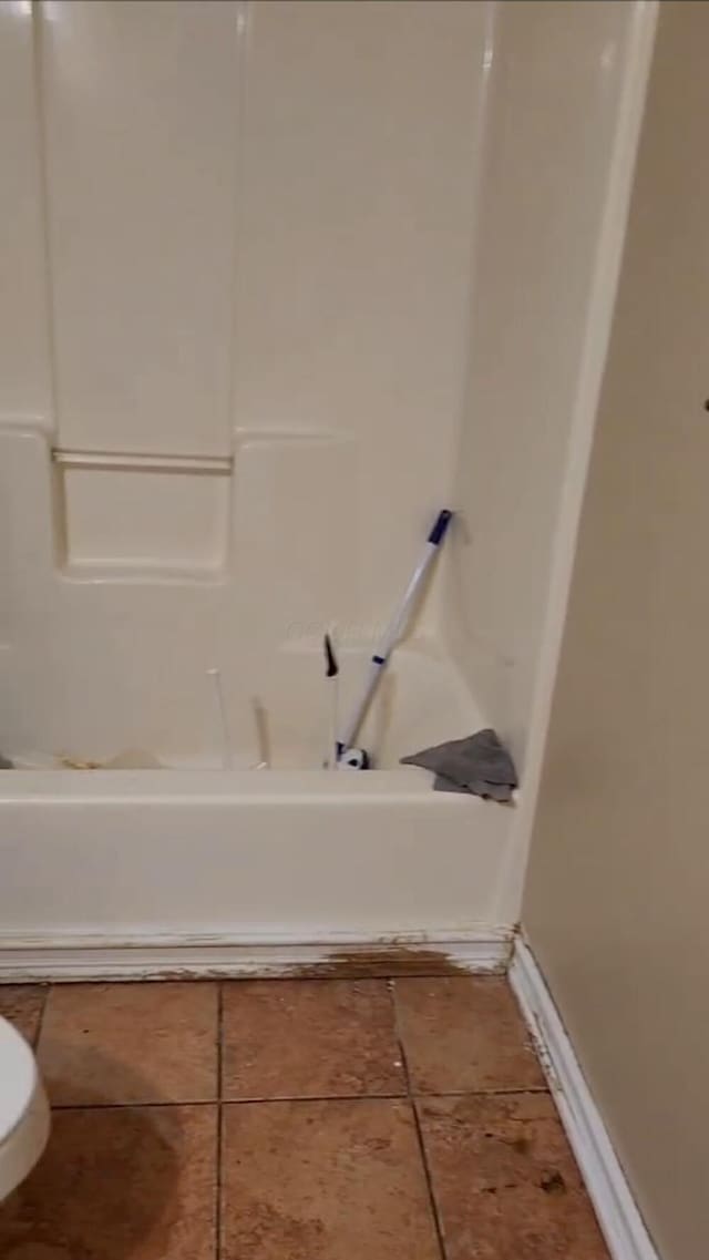 23454 Davis Rd, West Mansfield, OH 43358 - bathroom featuring  shower combination, toilet, and baseboards