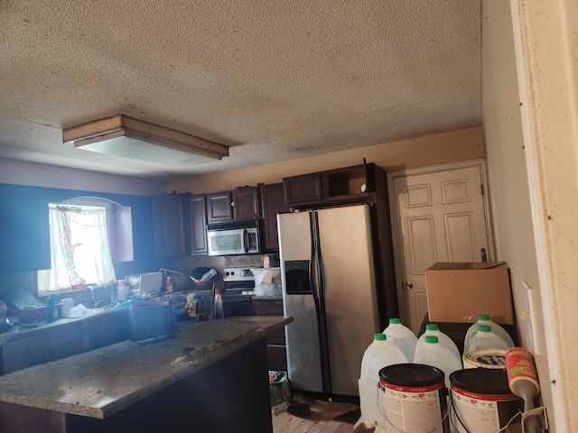 23454 Davis Rd, West Mansfield, OH 43358 - kitchen featuring appliances with stainless steel finishes, a textured ceiling, and dark brown cabinetry