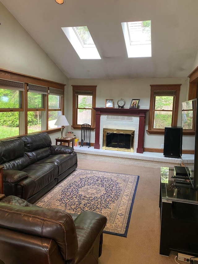 192 Bridle Path Ln, Granville, OH 43023 - carpeted living room featuring a skylight, vaulted ceiling, and a glass covered fireplace