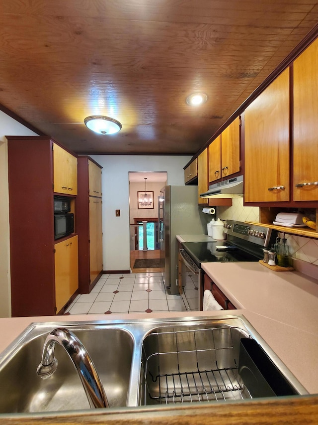 192 Bridle Path Ln, Granville, OH 43023 - kitchen with range with electric cooktop, under cabinet range hood, backsplash, light countertops, and baseboards