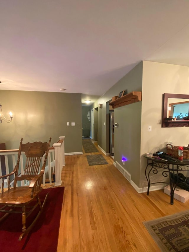 192 Bridle Path Ln, Granville, OH 43023 - hall featuring wood finished floors, a chandelier, and baseboards