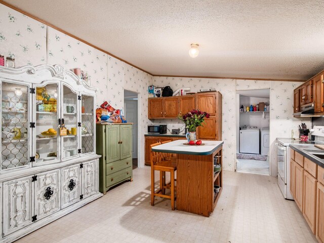 4015 County Road 25, Cardington, OH 43315 - kitchen featuring ornamental molding, washer and clothes dryer, wallpapered walls, a kitchen island, and a textured ceiling