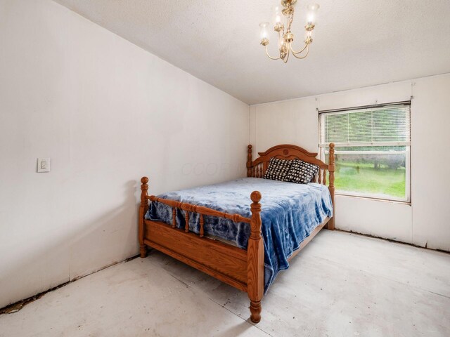 4015 County Road 25, Cardington, OH 43315 - bedroom with unfinished concrete flooring and a chandelier