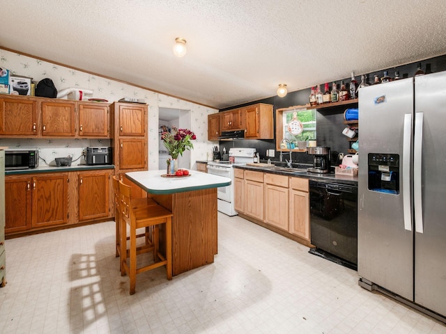 4015 County Road 25, Cardington, OH 43315 - kitchen with appliances with stainless steel finishes, wallpapered walls, a textured ceiling, light floors, and under cabinet range hood