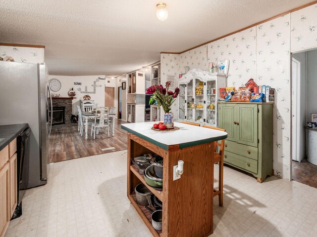 4015 County Road 25, Cardington, OH 43315 - kitchen with light floors, a textured ceiling, wallpapered walls, a center island, and ornamental molding