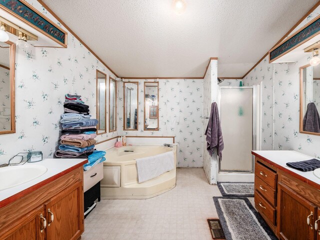 4015 County Road 25, Cardington, OH 43315 - bathroom with wallpapered walls, a shower stall, a textured ceiling, two vanities, and a bath