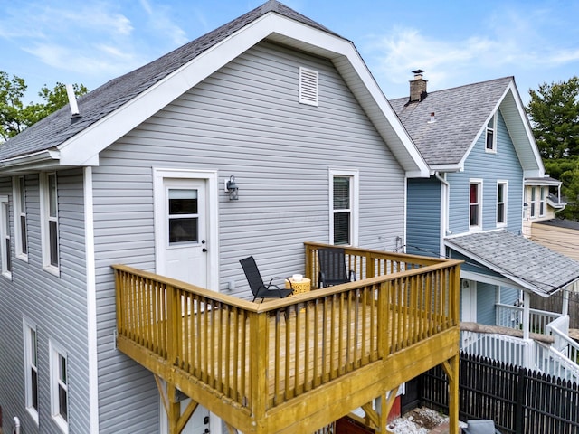 731 Siebert St, Columbus, OH 43206 - back of property with a shingled roof, a wooden deck, and a chimney