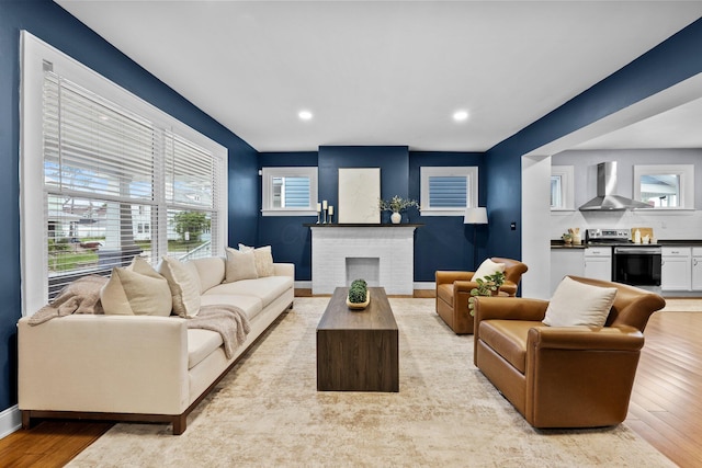 731 Siebert St, Columbus, OH 43206 - living room featuring light wood-style floors, a fireplace, recessed lighting, and baseboards
