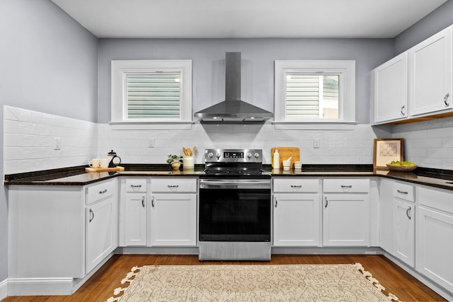 731 Siebert St, Columbus, OH 43206 - kitchen with stainless steel electric stove, wall chimney range hood, tasteful backsplash, and dark countertops