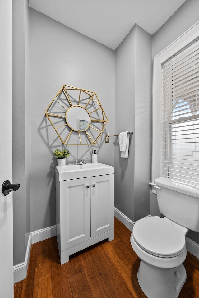 731 Siebert St, Columbus, OH 43206 - bathroom with wood finished floors, baseboards, vanity, and toilet