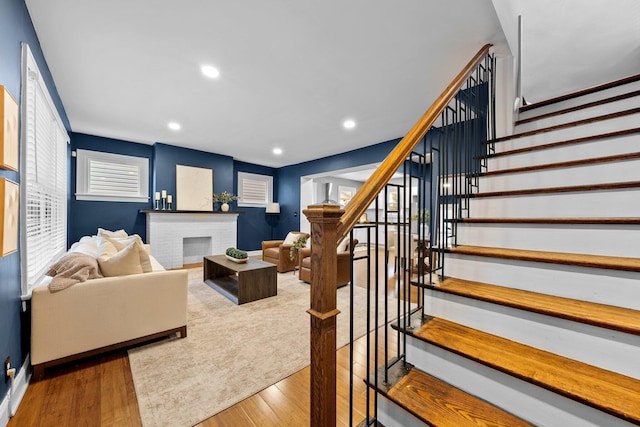 731 Siebert St, Columbus, OH 43206 - living area with stairs, wood finished floors, a brick fireplace, and recessed lighting