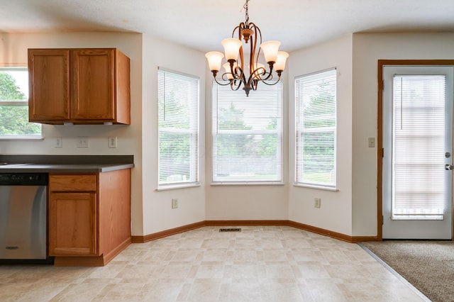 2378 Myrtle Valley Dr, Columbus, OH 43228 - kitchen featuring stainless steel dishwasher, healthy amount of natural light, brown cabinetry, and dark countertops