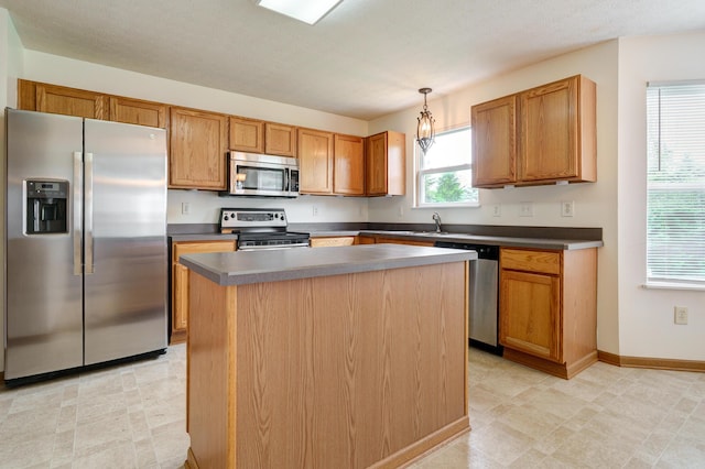 2378 Myrtle Valley Dr, Columbus, OH 43228 - kitchen featuring stainless steel appliances, a center island, decorative light fixtures, dark countertops, and light flooring