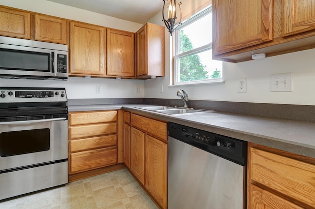 2378 Myrtle Valley Dr, Columbus, OH 43228 - kitchen featuring stainless steel appliances, a sink, and brown cabinetry