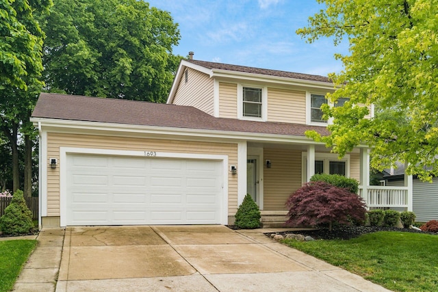1693 Hale Ct, Columbus, OH 43228 - view of front facade featuring driveway, an attached garage, covered porch, and a front yard