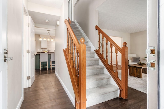 1693 Hale Ct, Columbus, OH 43228 - stairs with wood finished floors, baseboards, and a textured ceiling
