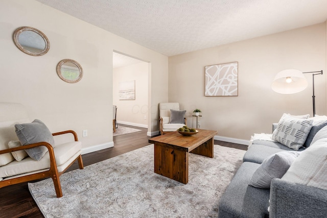 1693 Hale Ct, Columbus, OH 43228 - living area with wood finished floors, baseboards, and a textured ceiling