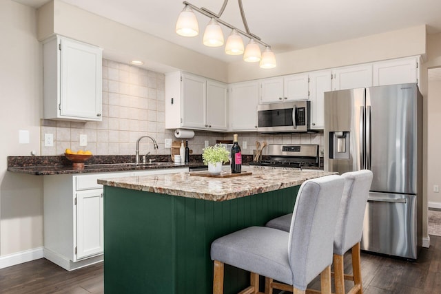 1693 Hale Ct, Columbus, OH 43228 - kitchen with stainless steel appliances, baseboards, a sink, dark wood-style floors, and decorative backsplash
