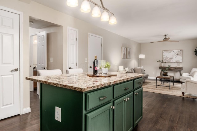 1693 Hale Ct, Columbus, OH 43228 - kitchen featuring green cabinetry, open floor plan, a kitchen island, dark wood-type flooring, and a ceiling fan
