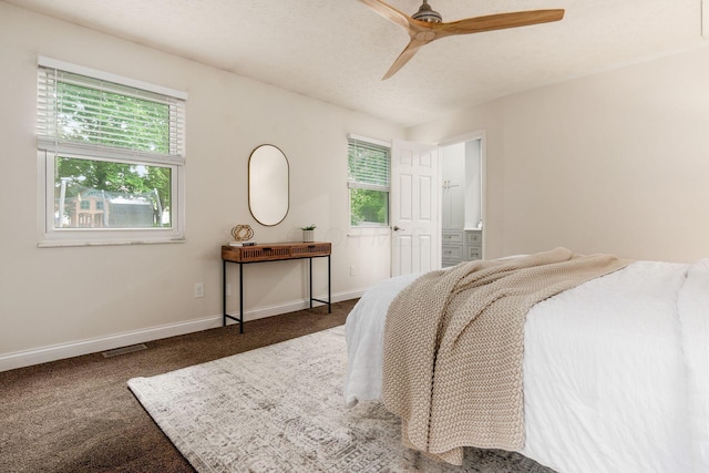1693 Hale Ct, Columbus, OH 43228 - carpeted bedroom with multiple windows, baseboards, ensuite bath, and a ceiling fan