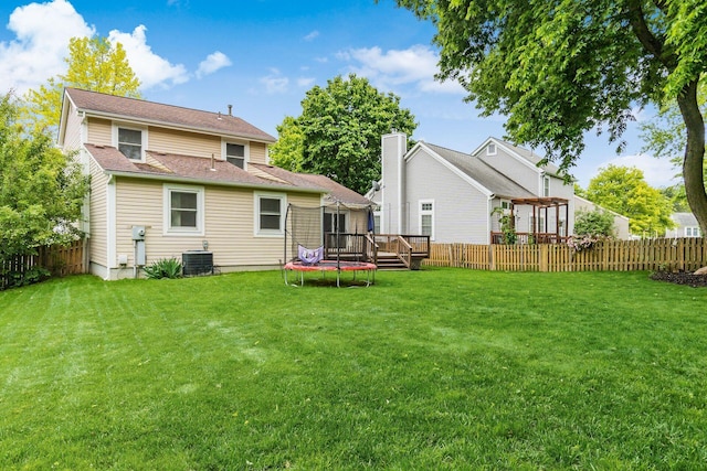 1693 Hale Ct, Columbus, OH 43228 - rear view of property featuring a deck, a trampoline, and central air condition unit
