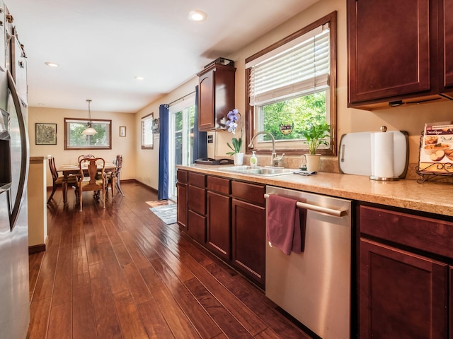 193 W Pearl St, West Jefferson, OH 43162 - kitchen with stainless steel appliances, a sink, dark wood-style flooring, light countertops, and decorative light fixtures