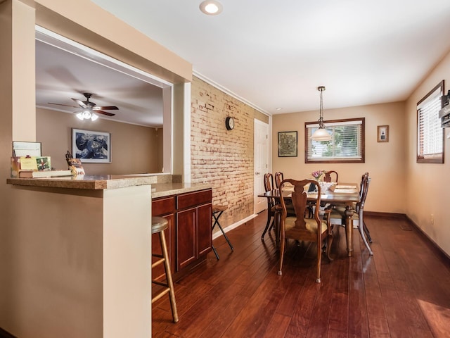 193 W Pearl St, West Jefferson, OH 43162 - dining space with baseboards, dark wood-style flooring, a ceiling fan, and brick wall