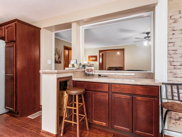 193 W Pearl St, West Jefferson, OH 43162 - kitchen with dark wood-style floors, ceiling fan, a breakfast bar area, and ornamental molding